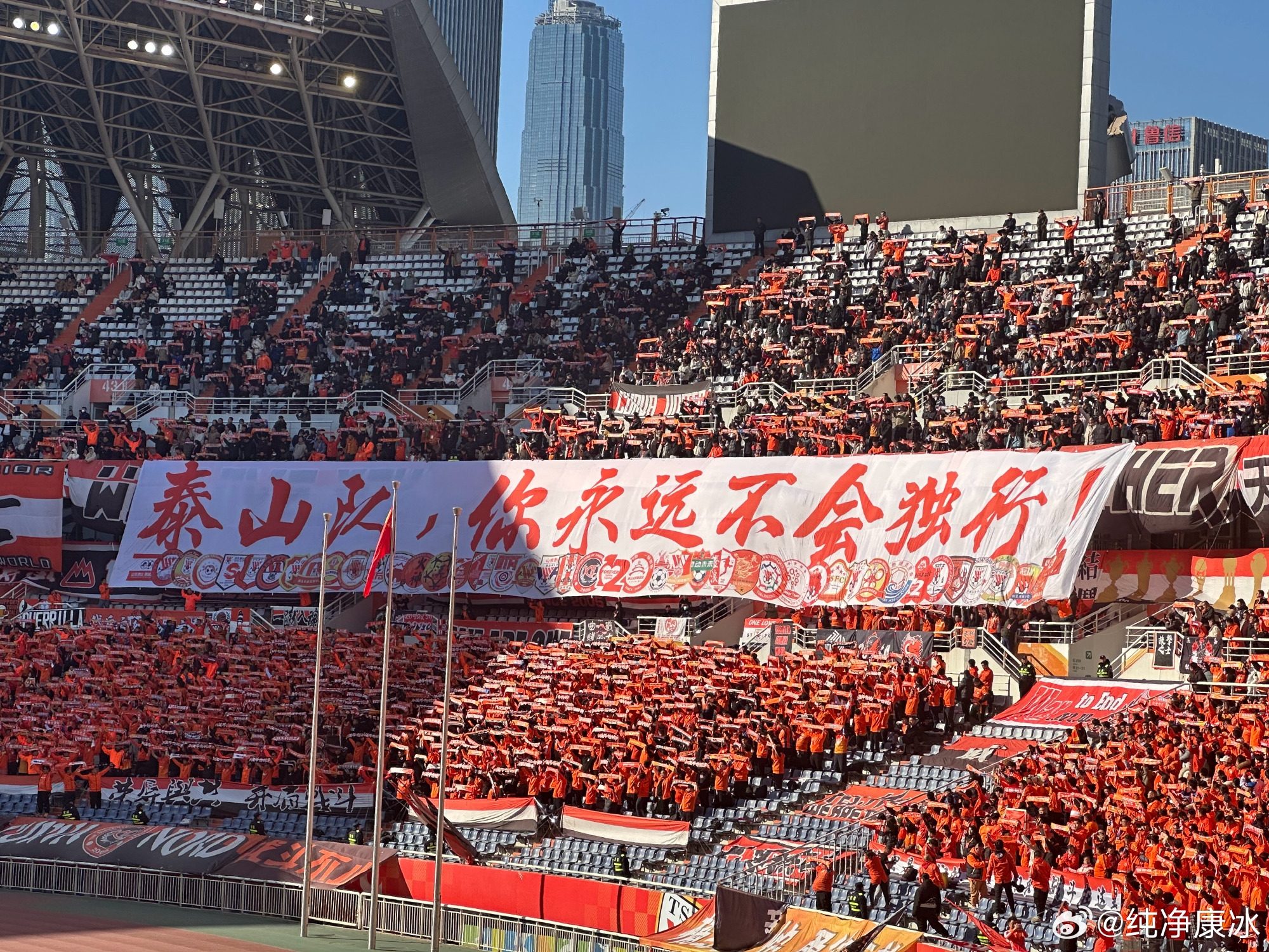  印有42家球迷會(huì)logo，泰山球迷拉橫幅：泰山隊(duì)，你永遠(yuǎn)不會(huì)獨(dú)行！